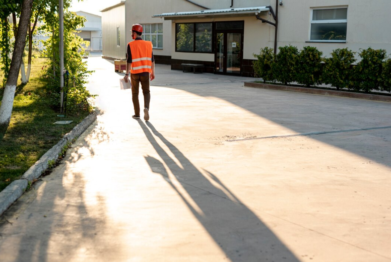 Worker-inspecting-a-sealed-concrete-driveway
