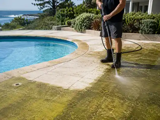 Pressure washing algae from a pool surround